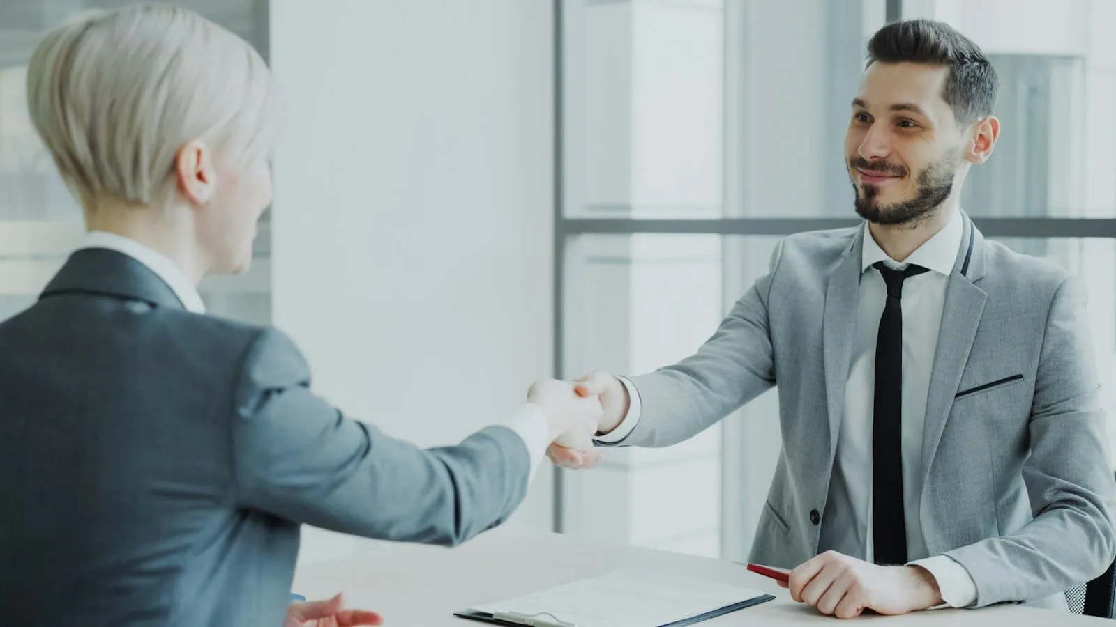 Two people shaking hands after a meeting