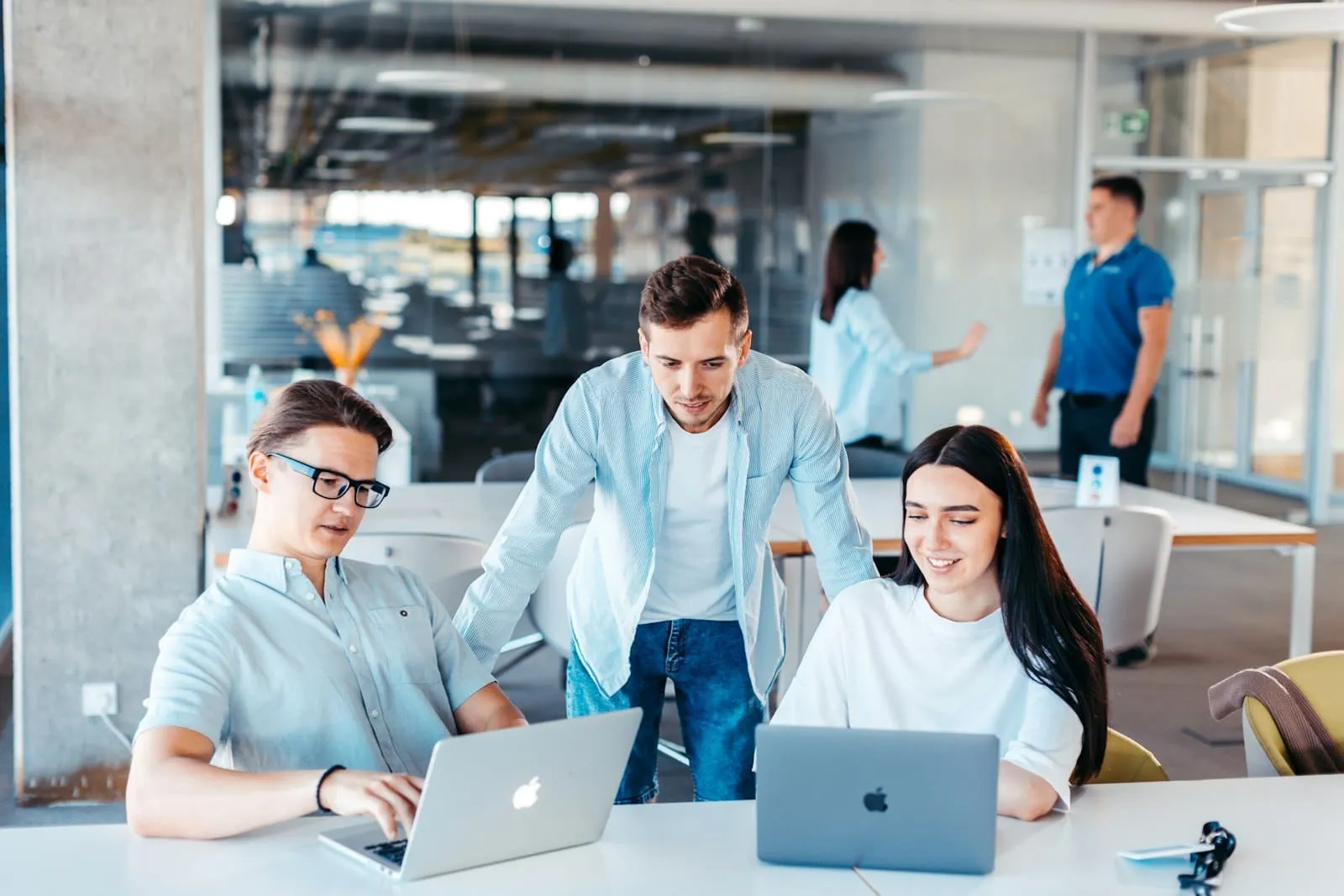 IT professionals working together on laptops